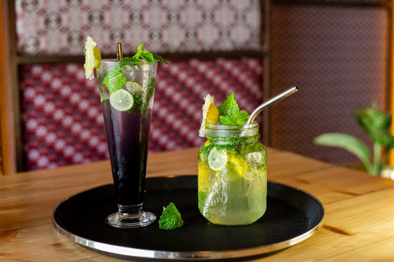 Two fresh mint mocktails served on a tray